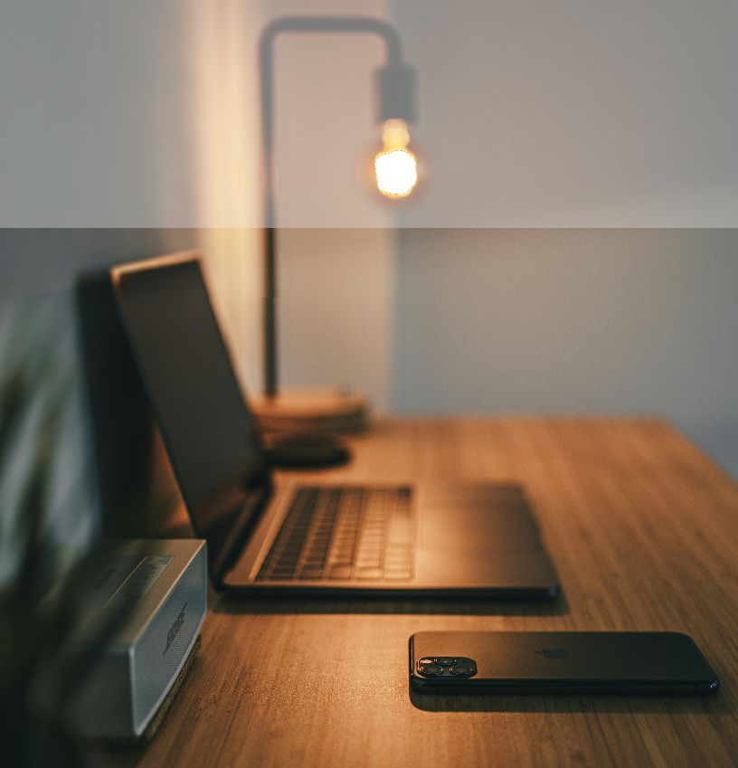 Lamp, laptop and phone on a desk